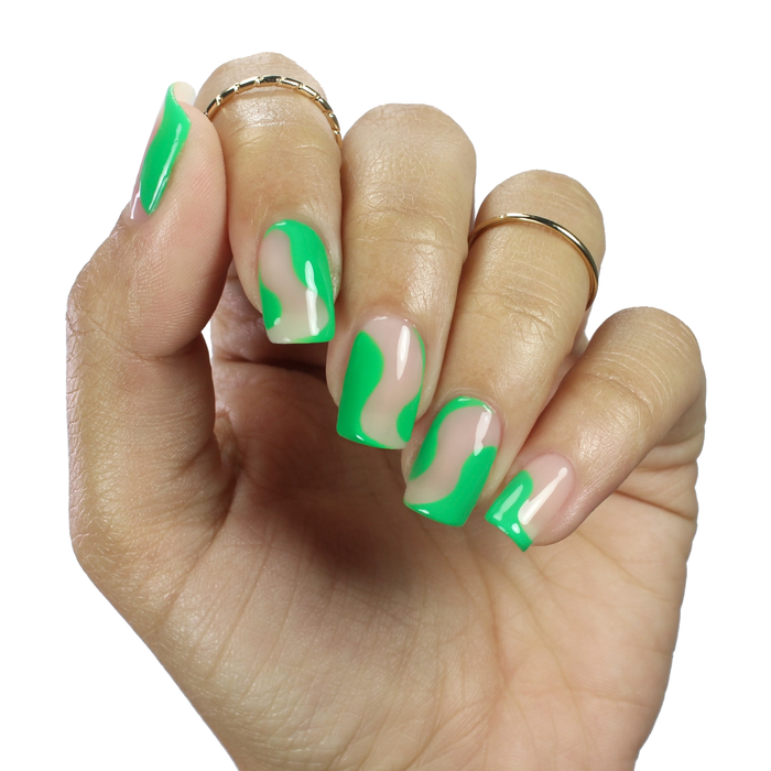 Green with Frenzy green swirl French tip nail art on a medium skin tone with rings