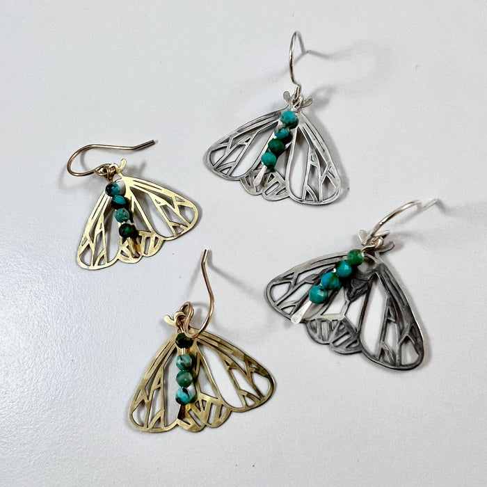 Handmade Peppered Moth earrings by Fluff Hardware, featuring detailed moth designs on silver hooks.