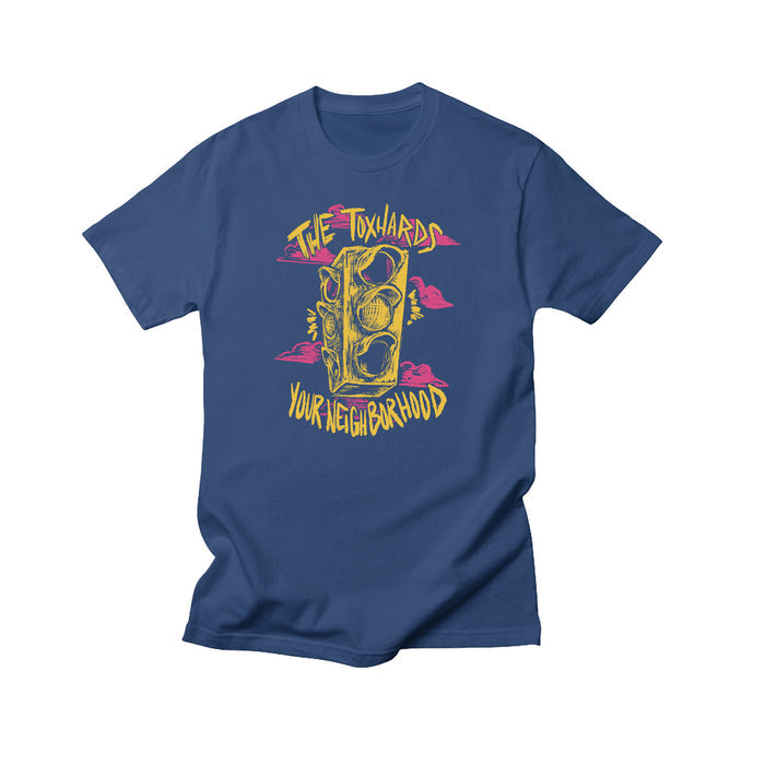 The Toxhards blue T-shirt with a yellow illustrated traffic light, pink clouds, and โThe Toxhardsโ above and โYour Neighborhoodโ below in stylized yellow font. Exclusive design by The Toxhards.