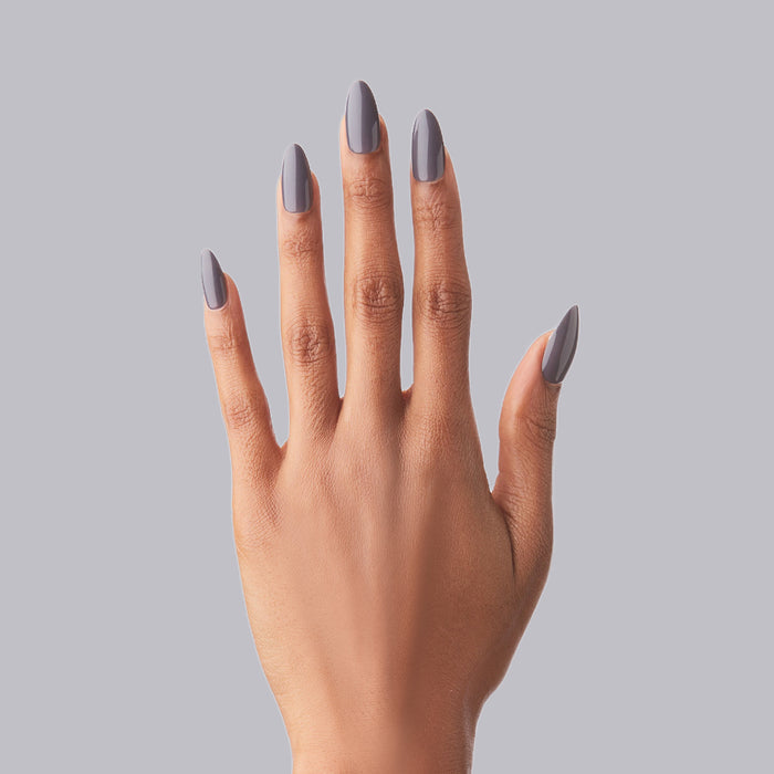 100% Chance - Press-On | Long | Almond showing hand with long almond press-on nails in moody neutral polish on gray background