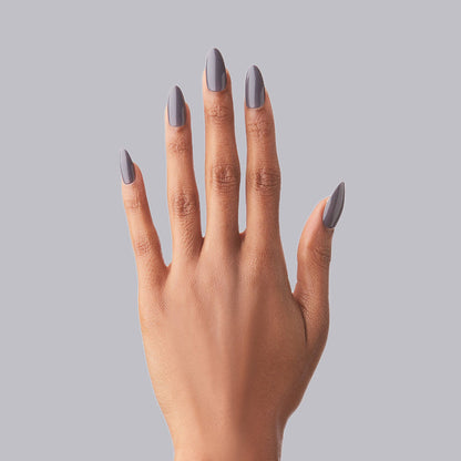 100% Chance - Press-On | Long | Almond showing hand with long almond press-on nails in moody neutral polish on gray background