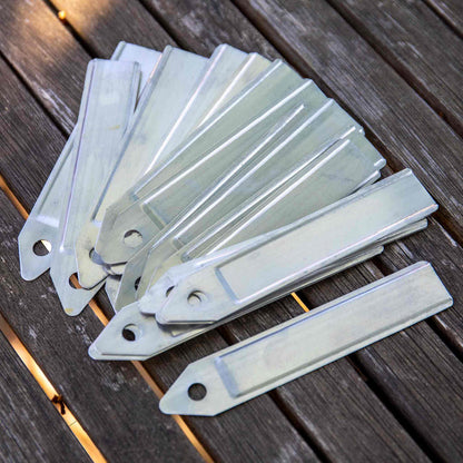 Set of metal tags on a wooden surface