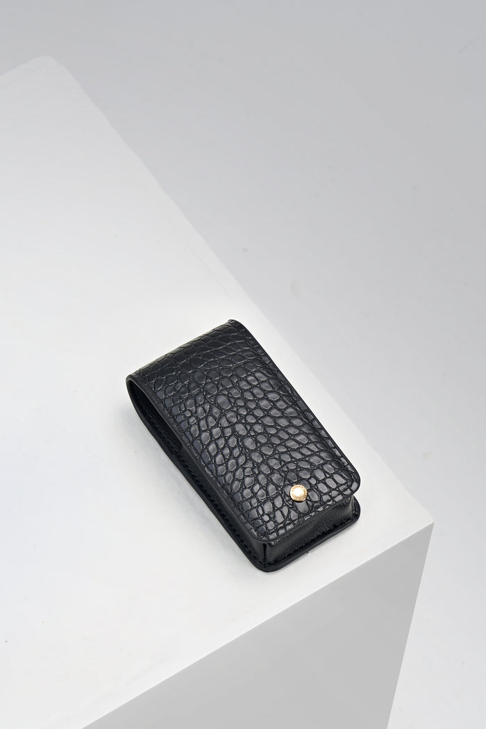 Aisling Black crocodile print faux leather Lipstick Holder with gold mag dot closure detail on the front displayed on a white plinth
