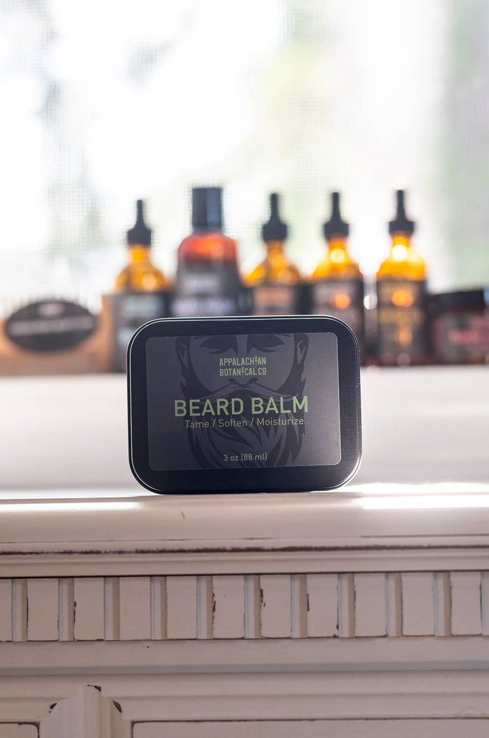 Men's grooming beard balm by Appalachian Botanical Co. in a jar with a natural wood lid, showcasing the product's texture and packaging.