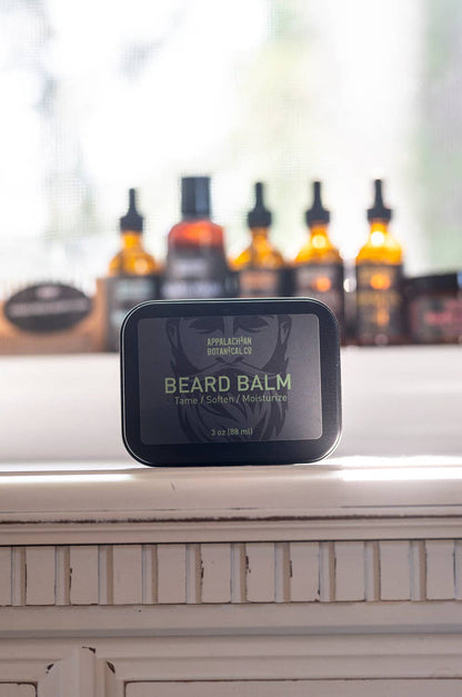 Men's grooming beard balm by Appalachian Botanical Co. in a jar with a natural wood lid, showcasing the product's texture and packaging.