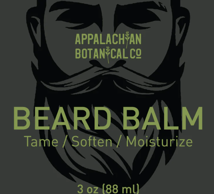 Men's grooming beard balm by Appalachian Botanical Co. in a metal tin with a natural, earthy label and a wooden beard comb beside it.