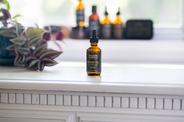 Close-up of Appalachian Botanical Co. beard oil in a gold bottle, showcasing men's grooming product for beard care.