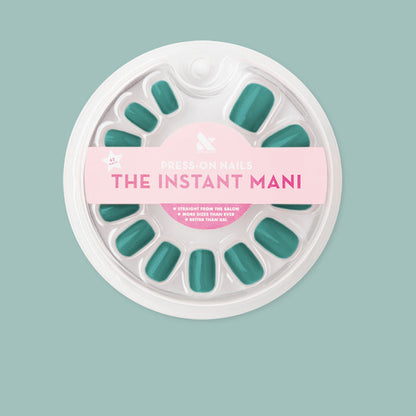 Pack of Besties - Press-On | Short | Squoval deep emerald green false nails in round white packaging on light teal background