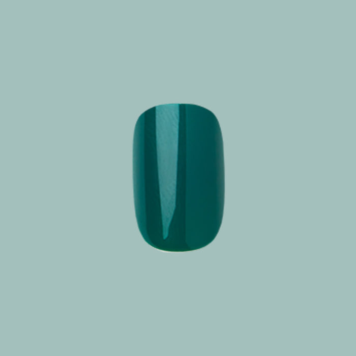 Besties - Press-On | Short | Squoval single deep emerald green short squoval false nail on muted teal background