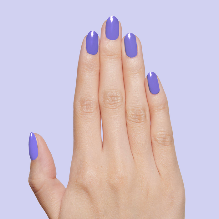 Hand displaying nails painted with Bold & Unshaken purple gel polish for a vibrant, long-lasting manicure by Olive and June