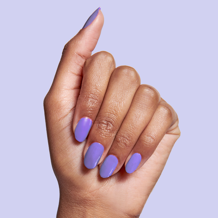 Hand with nails polished in Bold & Unshaken purple gel polish for a vibrant, long-lasting manicure by Olive and June