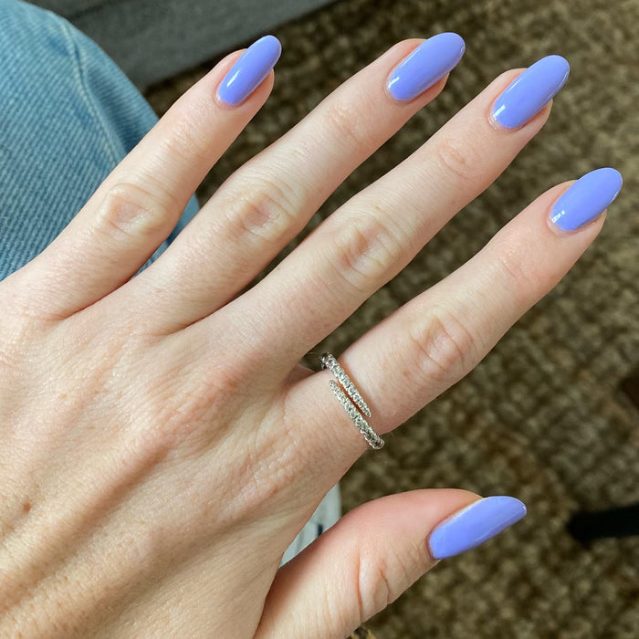 Hand with nails polished in Bold & Unshaken vibrant purple gel polish showing a smooth, long-lasting manicure