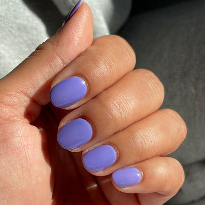 Hand with nails painted in Bold & Unshaken purple gel polish showing a smooth, long-lasting manicure by Olive and June