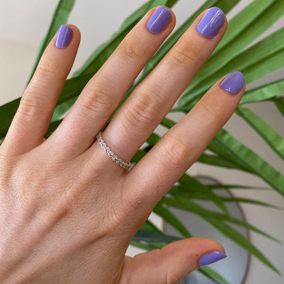 Hand with nails painted in Bold & Unshaken purple gel polish showing a vibrant, long-lasting manicure by Olive and June