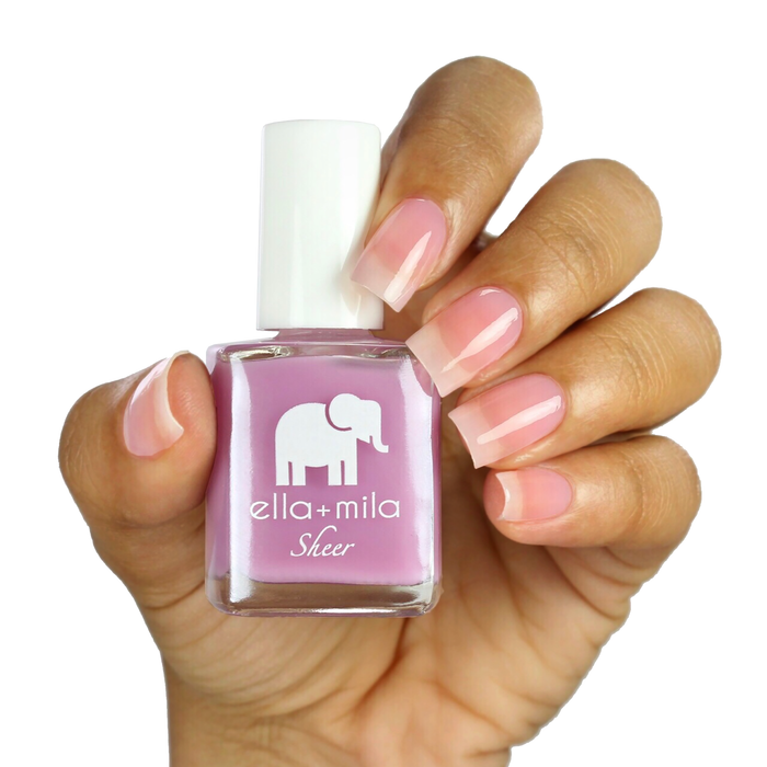 Bold sheer lavender tint nail polish on a medium skin tone, hand holding the bottle