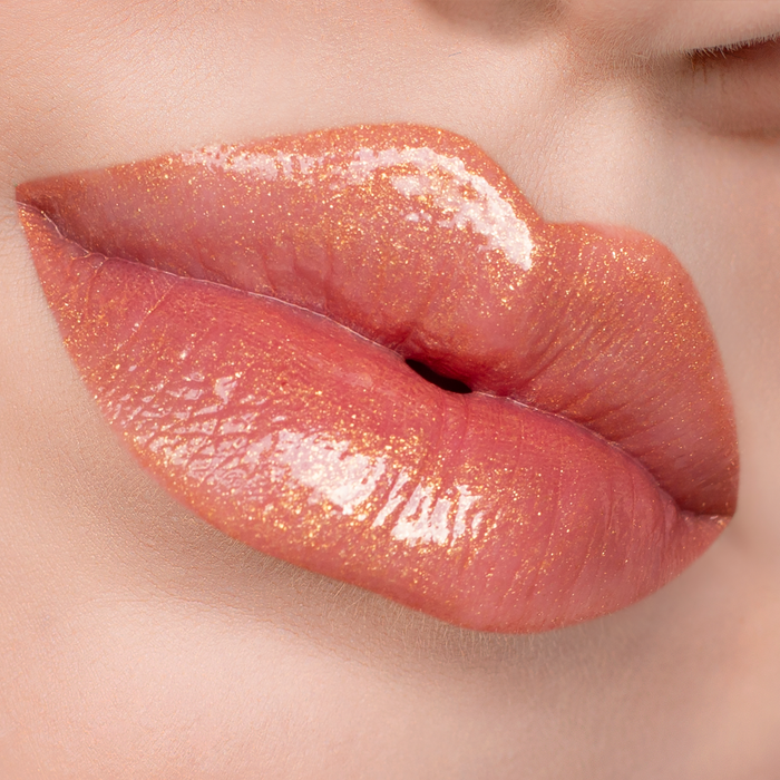 Bronze Babe golden shimmer lip gloss on lips, light skin tone close-up