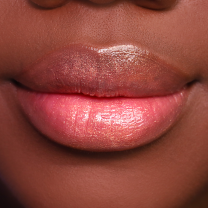Bronze Babe bronze shimmer lip gloss on lips, medium-deep skin tone