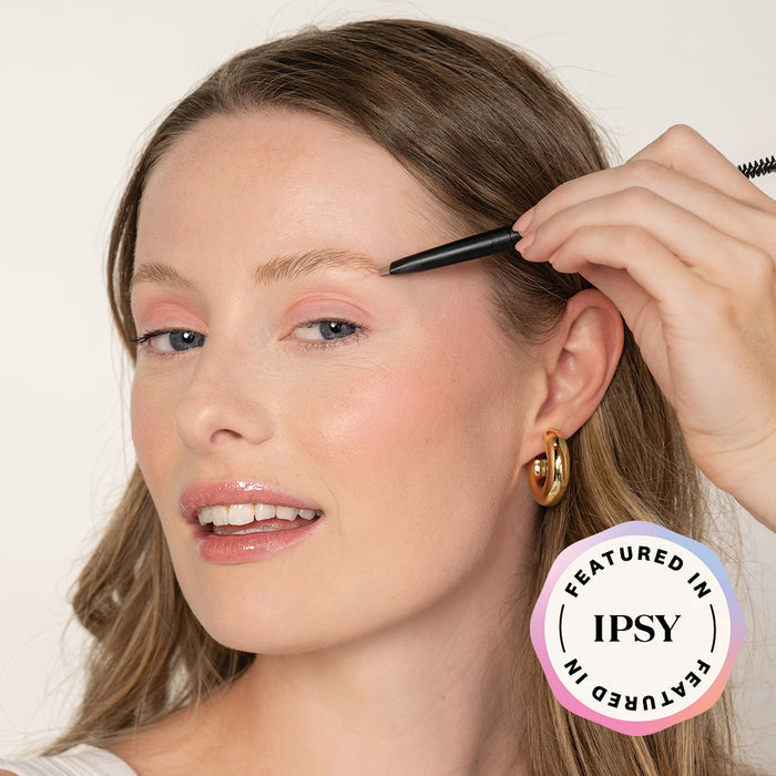 Woman applying eyebrow product with a brush, featuring IPSY logo.