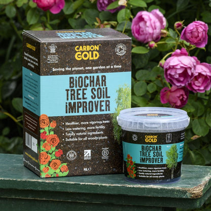 The image shows a package and container of Carbon Gold Biochar Tree Soil Improver with a background of pink roses.