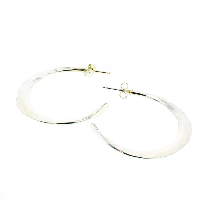 Silver statement hoop earrings with smooth, reflective oval shape