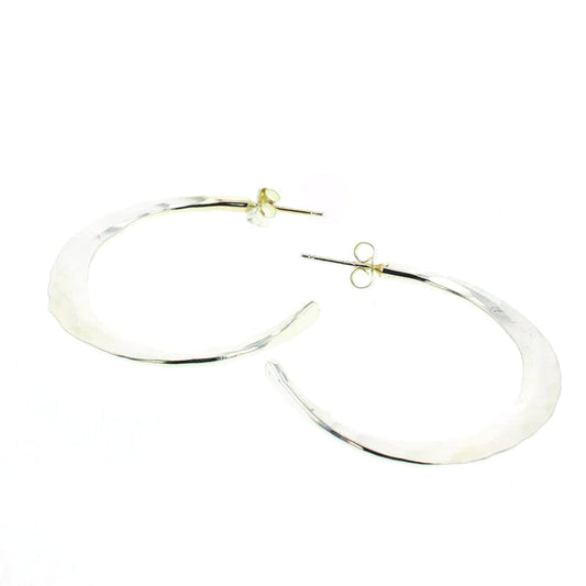 Silver statement hoop earrings with smooth, reflective oval shape