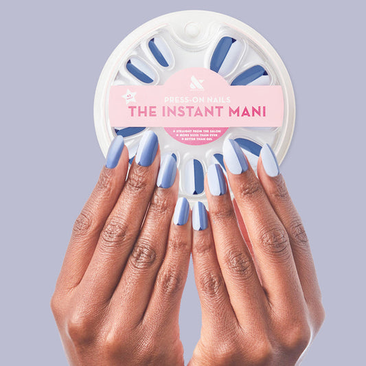 Colorblock Triangle - Press-On | Medium | Oval showing medium oval false nails in three blue shades with triangle accent mani on hands