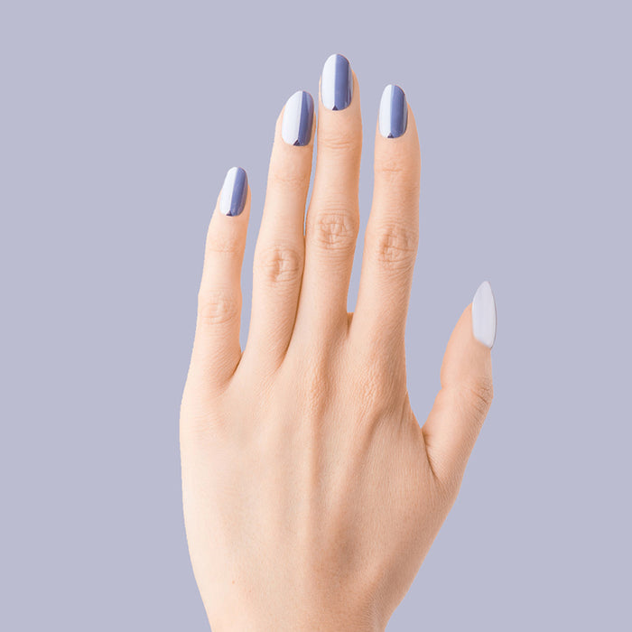 Colorblock Triangle - Press-On | Medium | Oval showing medium oval false nails with varied blue shades and triangle accent on hand