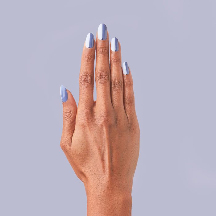 Colorblock Triangle - Press-On | Medium | Oval showing medium oval press-on nails in varied blue shades with triangle accents on hand