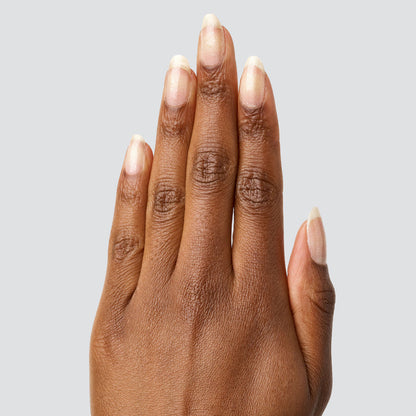 Hand with natural nails featuring COSMIC clear polish for a subtle shimmer and long-lasting manicure finish