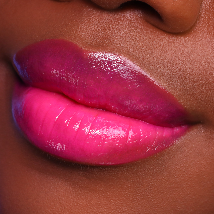Dream Up magenta pink lipstick on lips, deep skin tone close-up
