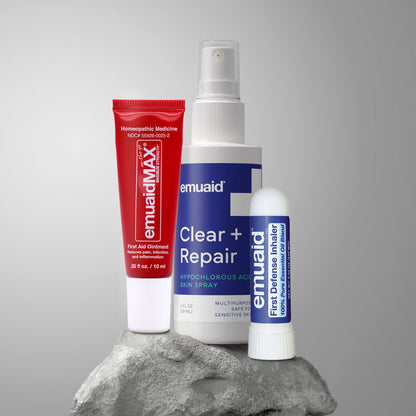Three emuaid products on a gray rock with a gray background