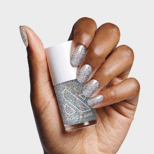 Hand displaying nails painted with Exclamation Point silver holographic glitter polish for a sparkly at-home mani