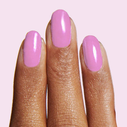 Fingers with nails painted in Fierce & Loving lilac gel polish for a smooth, long-lasting manicure by Olive and June
