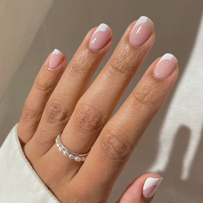 First Birthday iridescent glitter over a sheer pink French manicure with rings