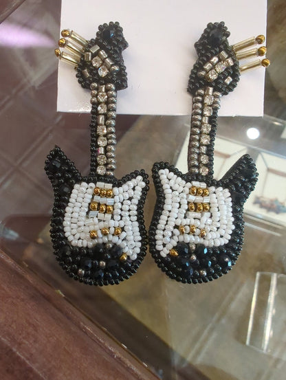 Colorful beaded earrings from Camel Threads featuring vibrant, multi-colored beads and a dangling design.