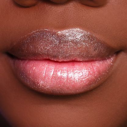Get the Glow shimmer lip gloss on lips, medium-deep skin tone