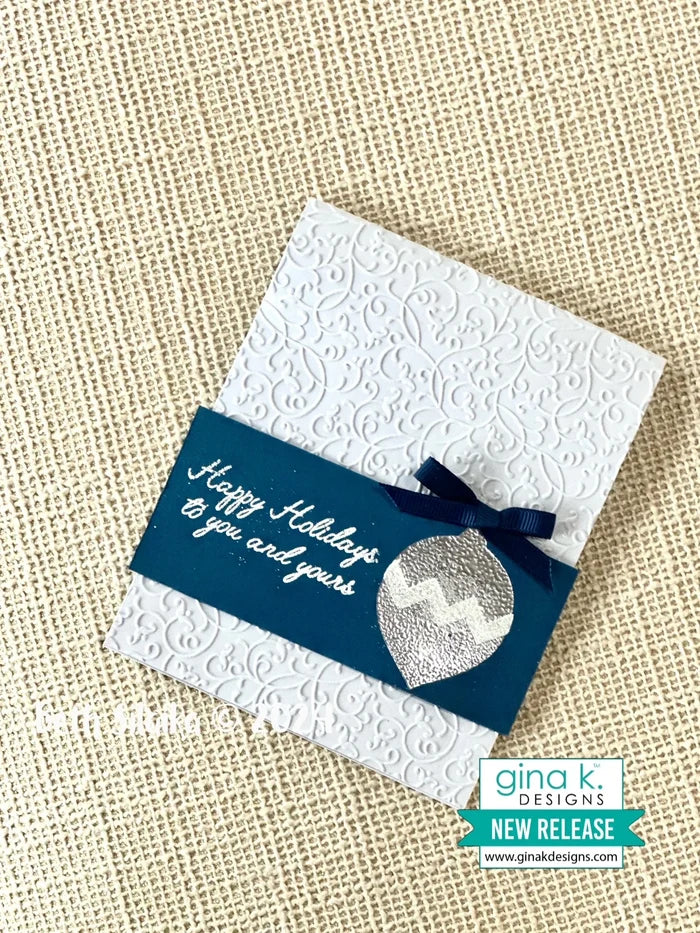 Gina K. Designs - Stamp &amp; Die Set - Holiday Ornaments. Holiday Ornaments is a stamp set by Beth Silaika. This set is made of premium clear photopolymer and measures 6" X 8". Made in the USA. Available at Embellish Away located in Bowmanville Ontario Canada. Card example by Beth Silaika.