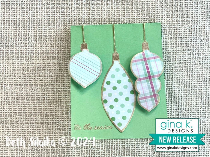 Gina K. Designs - Stamp &amp; Die Set - Holiday Ornaments. Holiday Ornaments is a stamp set by Beth Silaika. This set is made of premium clear photopolymer and measures 6" X 8". Made in the USA. Available at Embellish Away located in Bowmanville Ontario Canada. Card example by Beth Silaika.