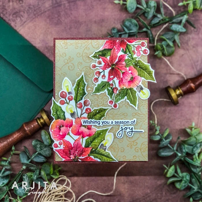 Gina K. Designs - Stamp &amp; Die Set - Joyful Season. Joyful Season is a stamp set by Arjita Singh. This set is made of premium clear photopolymer and measures 6" X 8". Made in the USA. Available at Embellish Away located in Bowmanville Ontario Canada. Card example by Arjita Singh.