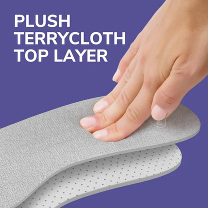 Hand pressing a gray cushioning insole showing layered top and foam base