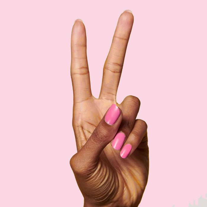 Hand showing peace sign with nails painted Grateful & Kind pure pink gel polish for a smooth at-home manicure
