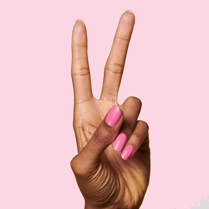 Hand showing peace sign with nails painted Grateful & Kind pure pink gel polish for a smooth at-home manicure