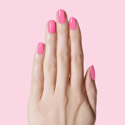 Hand with nails painted Grateful & Kind pure pink gel polish for a smooth and long-lasting at-home manicure by Olive and June