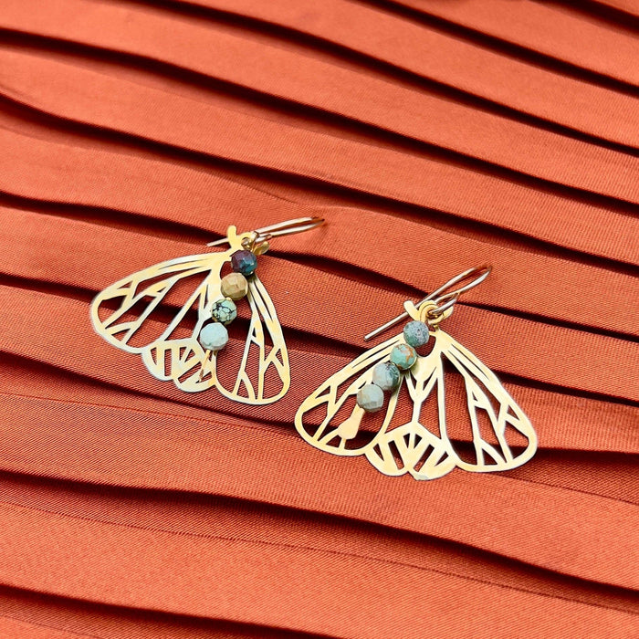 Handmade Peppered Moth earrings from Fluff Hardware featuring detailed black and white moth designs on silver hooks.