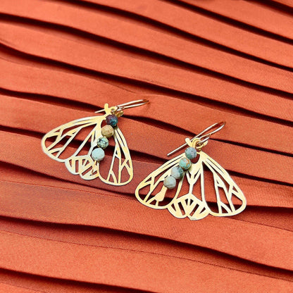 Handmade Peppered Moth earrings from Fluff Hardware featuring detailed black and white moth designs on silver hooks.