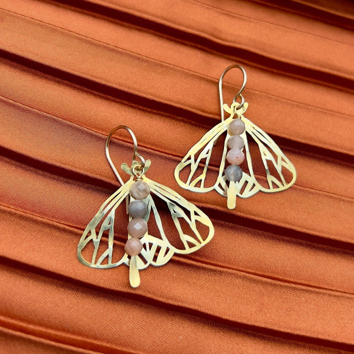 Handmade Peppered Moth earrings by Fluff Hardware showing detailed black and white moth design on silver hooks.