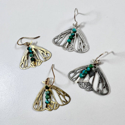 Handmade Peppered Moth earrings by Fluff Hardware, featuring detailed moth designs on silver hooks.