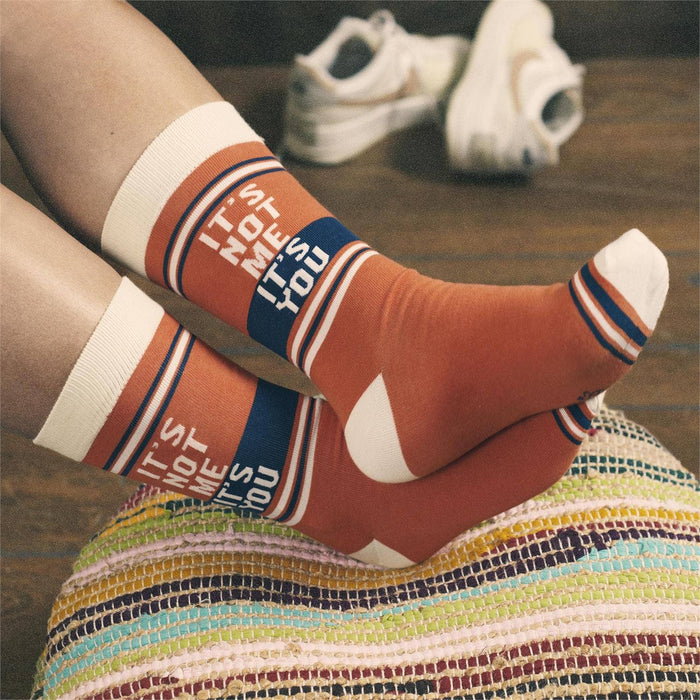 Questionables It's Not Me It's You Socks featuring humorous text and colorful design on soft fabric.