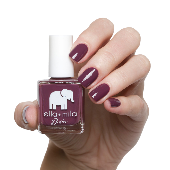 La Vie en Rose dark berry nail polish manicure on a light skin tone with the bottle