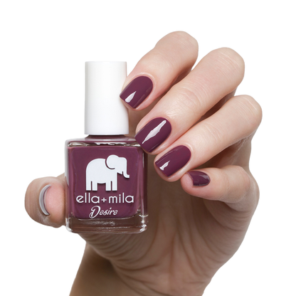 La Vie en Rose dark berry nail polish manicure on a light skin tone with the bottle